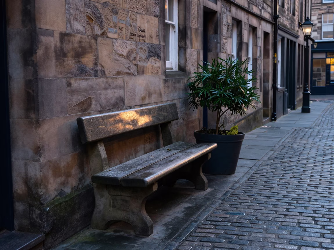 Edinburgh street scene with stone bench and potted plant after sunrise in in Edinburgh, United Kingdom