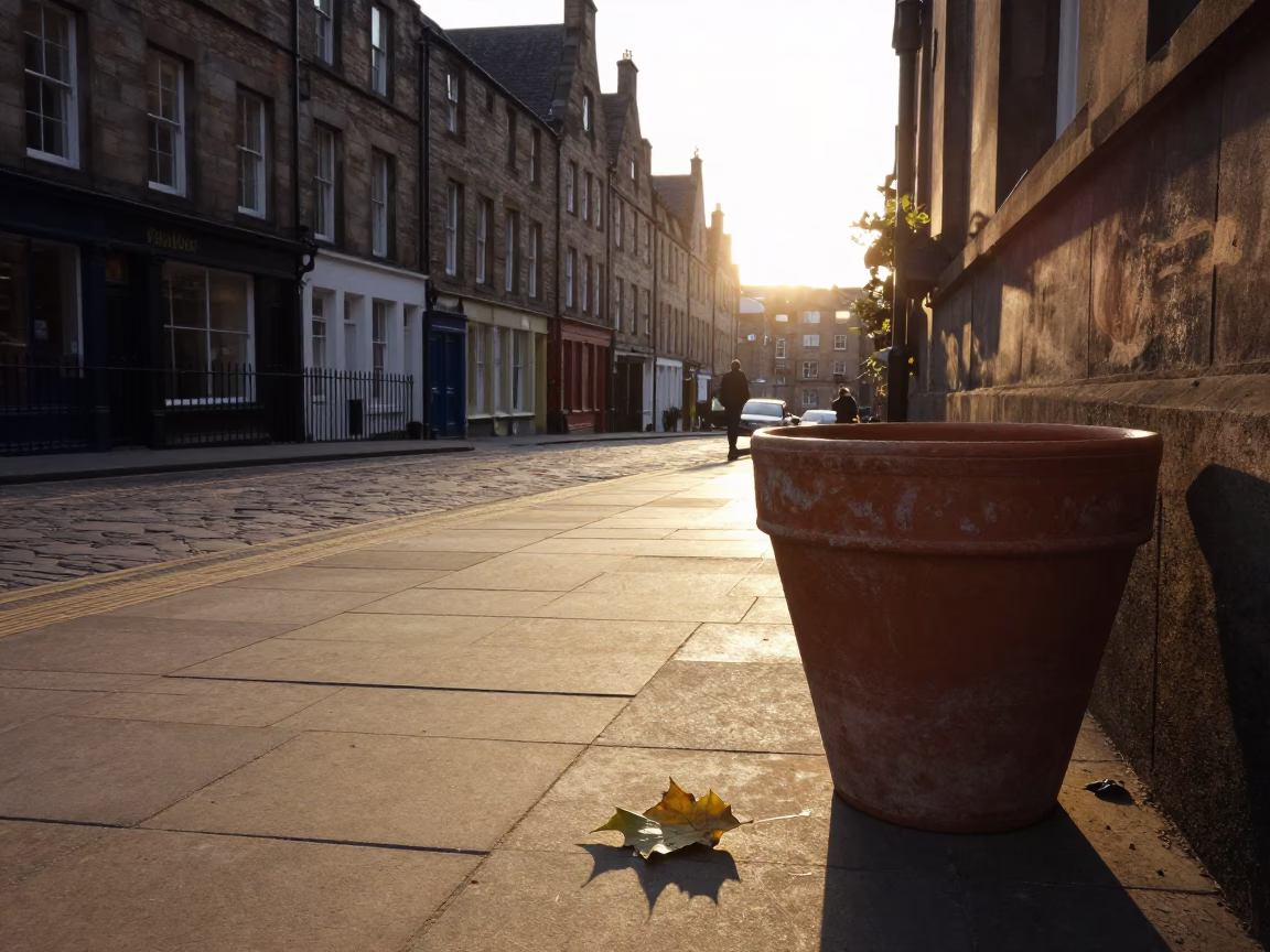 Edinburgh Sunset Street Scene with Terracotta Pot and Leaf Shadows on Tiled Floor in in Edinburgh, United Kingdom