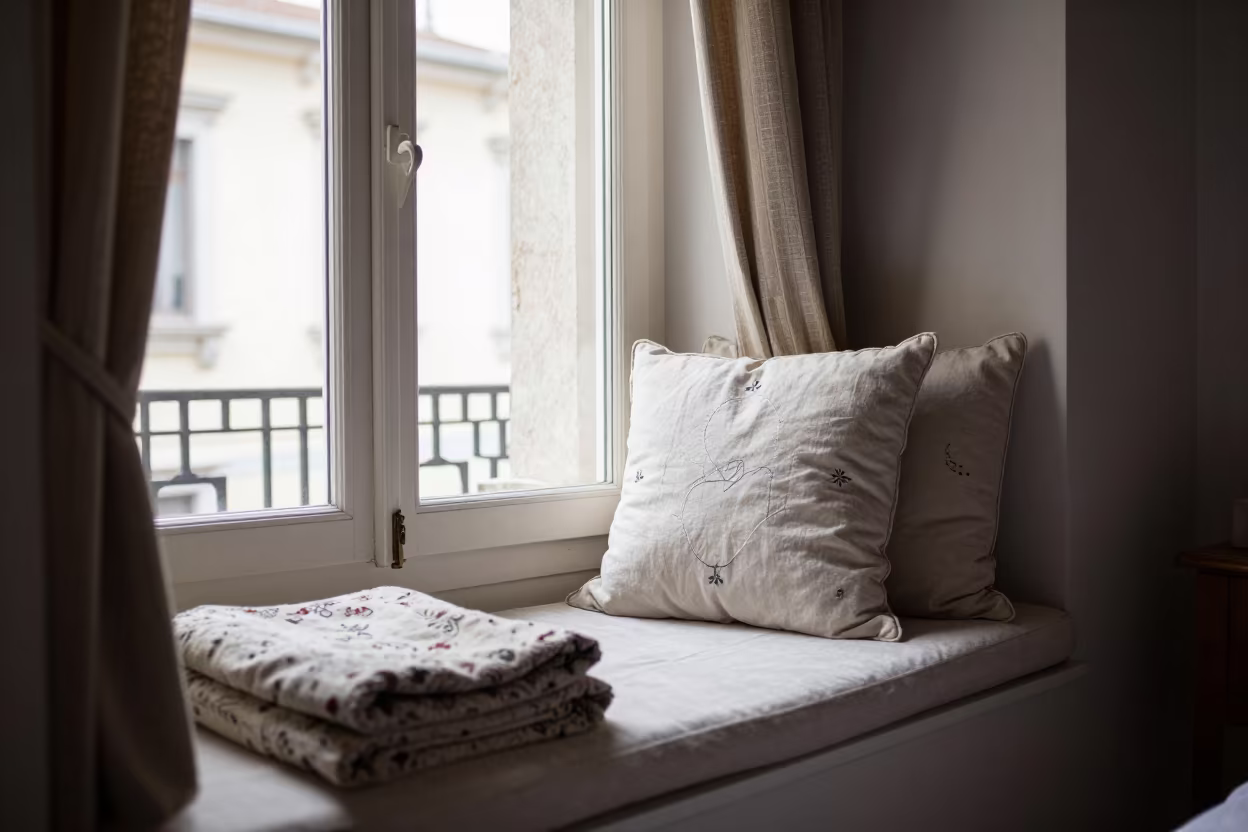 Embroidered Window Seat in Trieste Bedroom in in a candlelit bedroom in Trieste