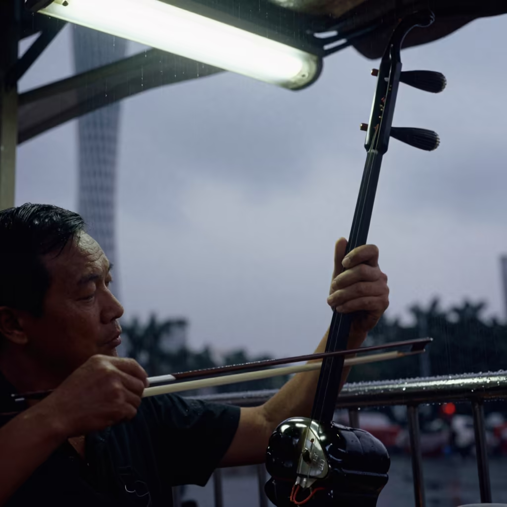 Erhu Player on Guangzhou Bridge Before Dawn in at a street corner busking spot in Guangzhou