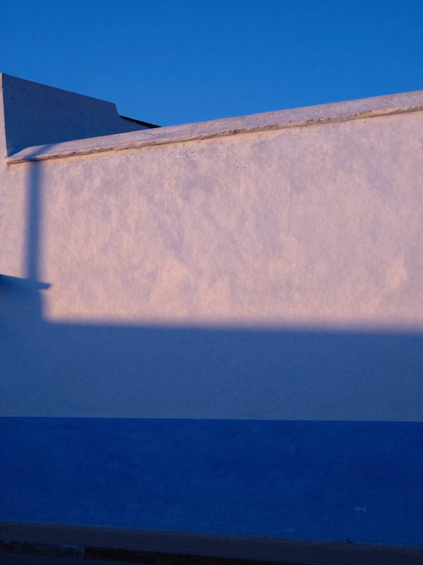 Essaouira Morocco Pre-Dawn Blue Hour Light Striking Whitewashed Wall and Blue Door in in Essaouira, Morocco