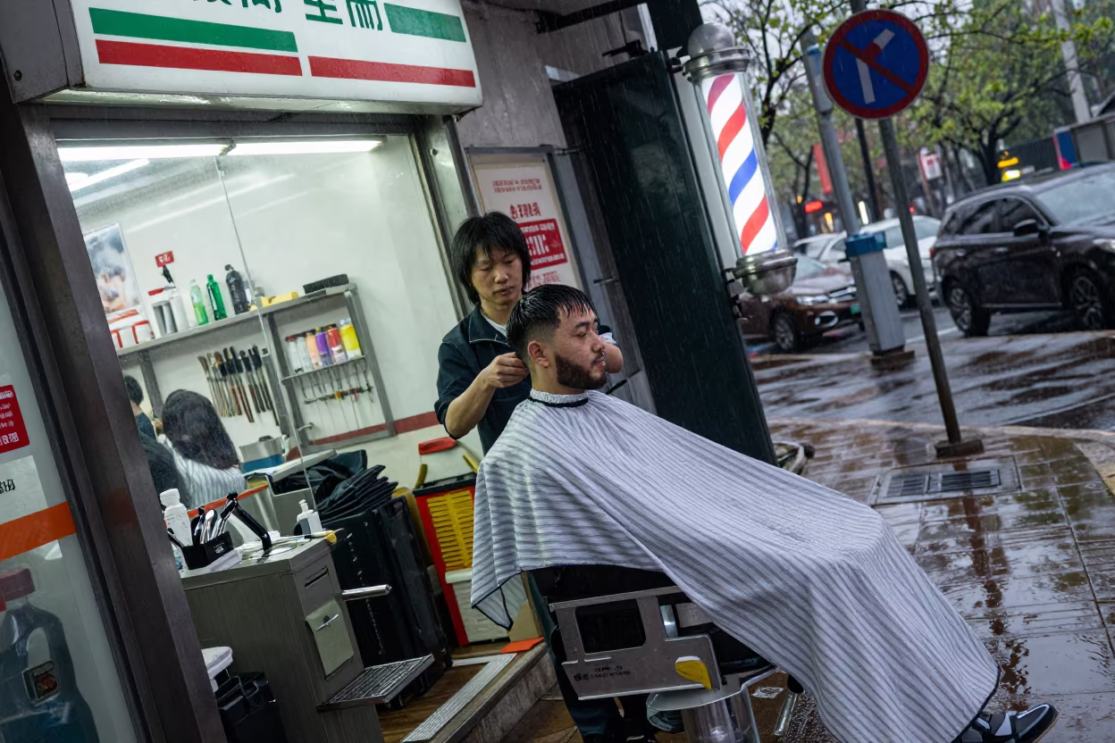 Evening Barber at Tram Stop in Zhengzhou Rain in outside a fluorescent convenience store in Zhengzhou