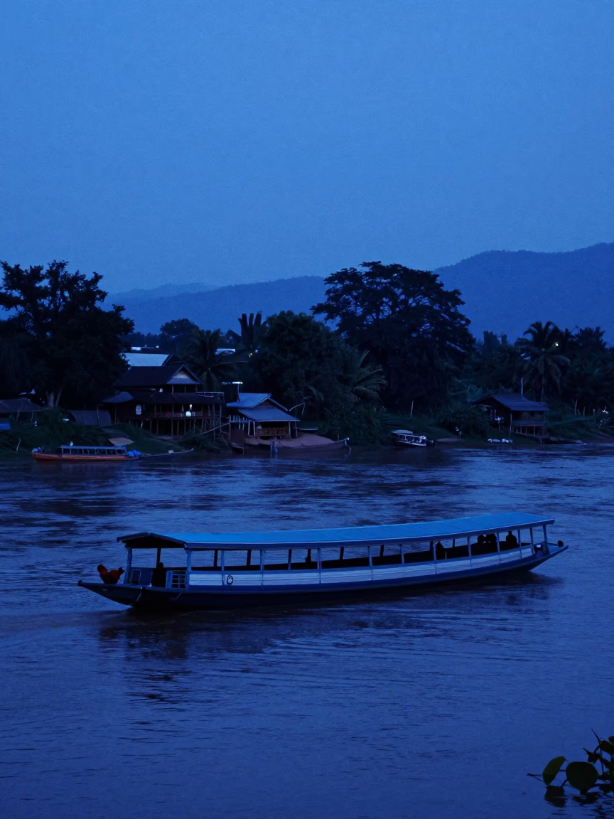 Evening Barge Navigation Along Mekong River in Luang Prabang Laos Blue Hour in in Luang Prabang, Laos