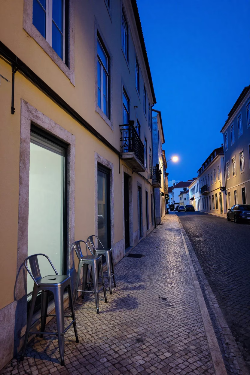Evening Blue Light Lisbon Street Scene with Bar Stools and Local Life in in Lisbon, Portugal