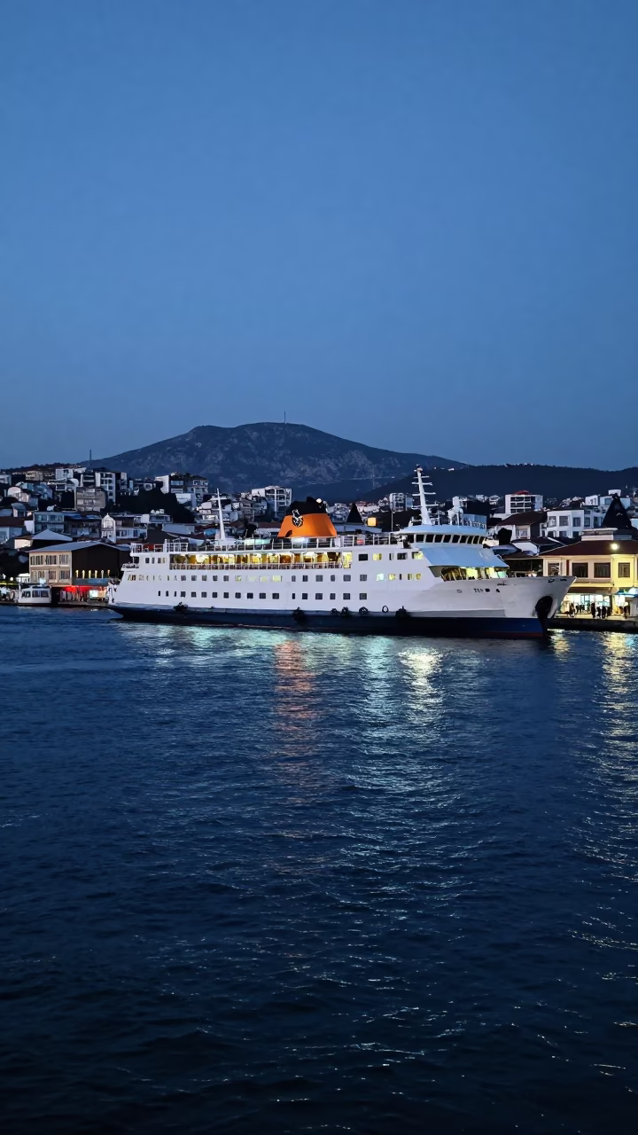 Evening Ferry Departure from Izmir Harbor with Mountain Backdrop Under Twilight Sky in in Izmir, Turkey