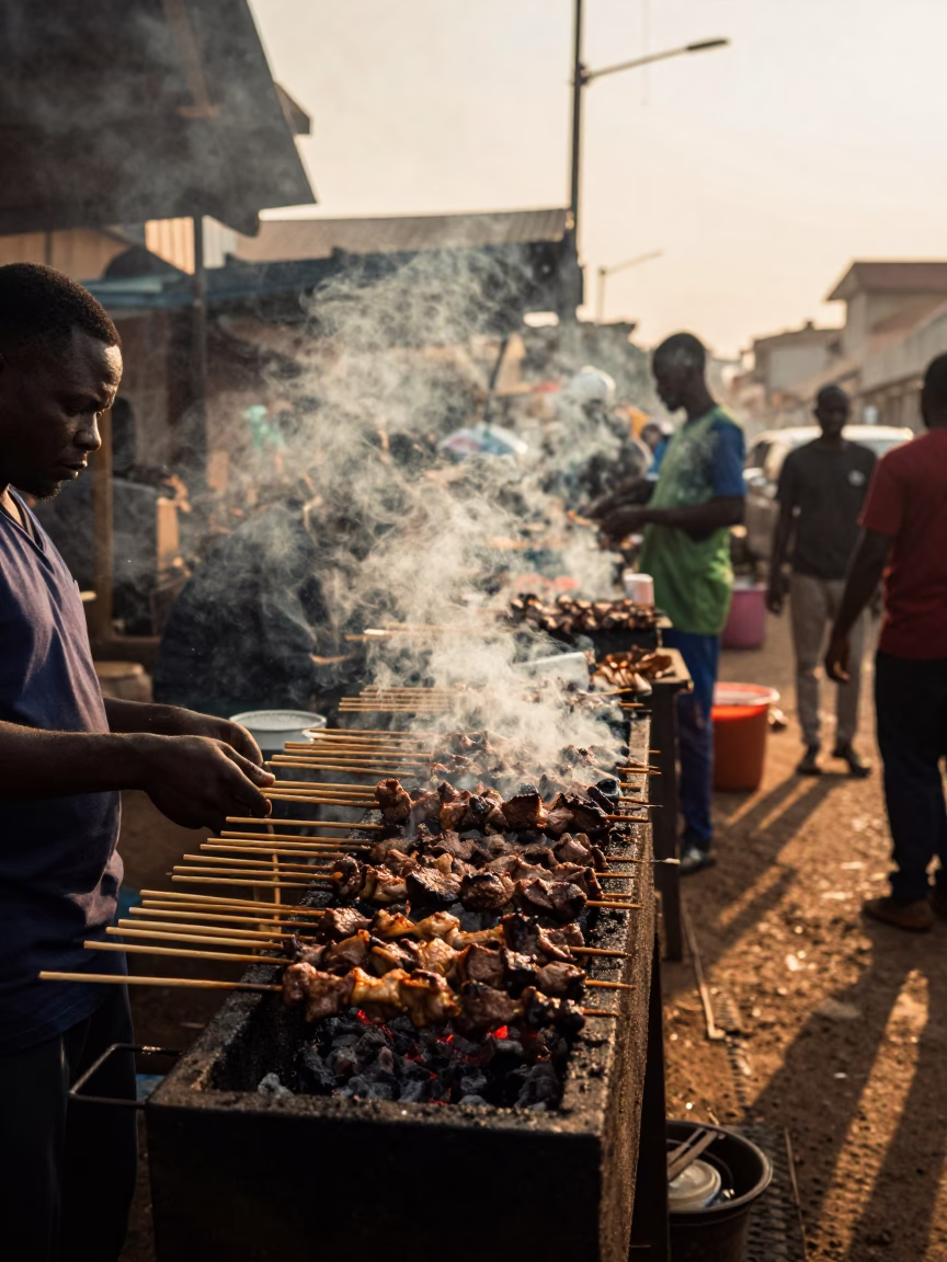 Evening Street Food Scene in Accra Ghana with Suya Skewers and Local Market Activity in in Accra, Ghana