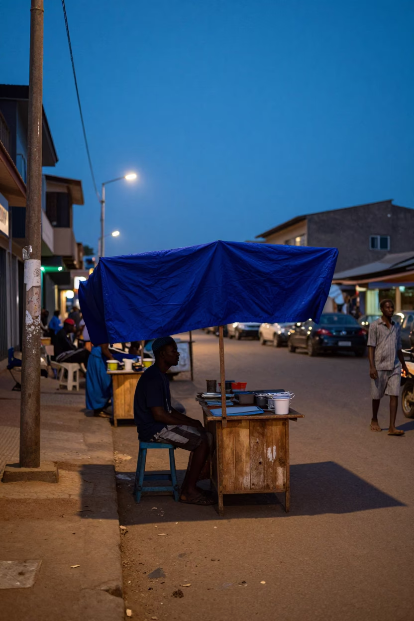 Evening street scene in Accra Ghana with indigo fabric and local commerce in in Accra, Ghana
