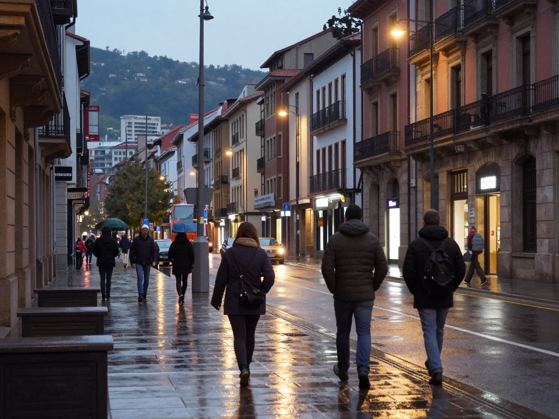 Evening Street Scene in Bilbao Spain with Raincoats and City Lights in in Bilbao, Spain
