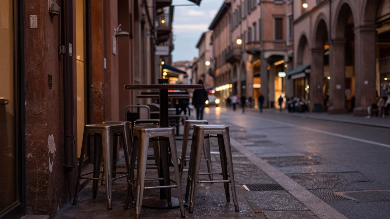 Evening Street Scene in Bologna Italy with Bar Stools and City Lights in in Bologna, Italy