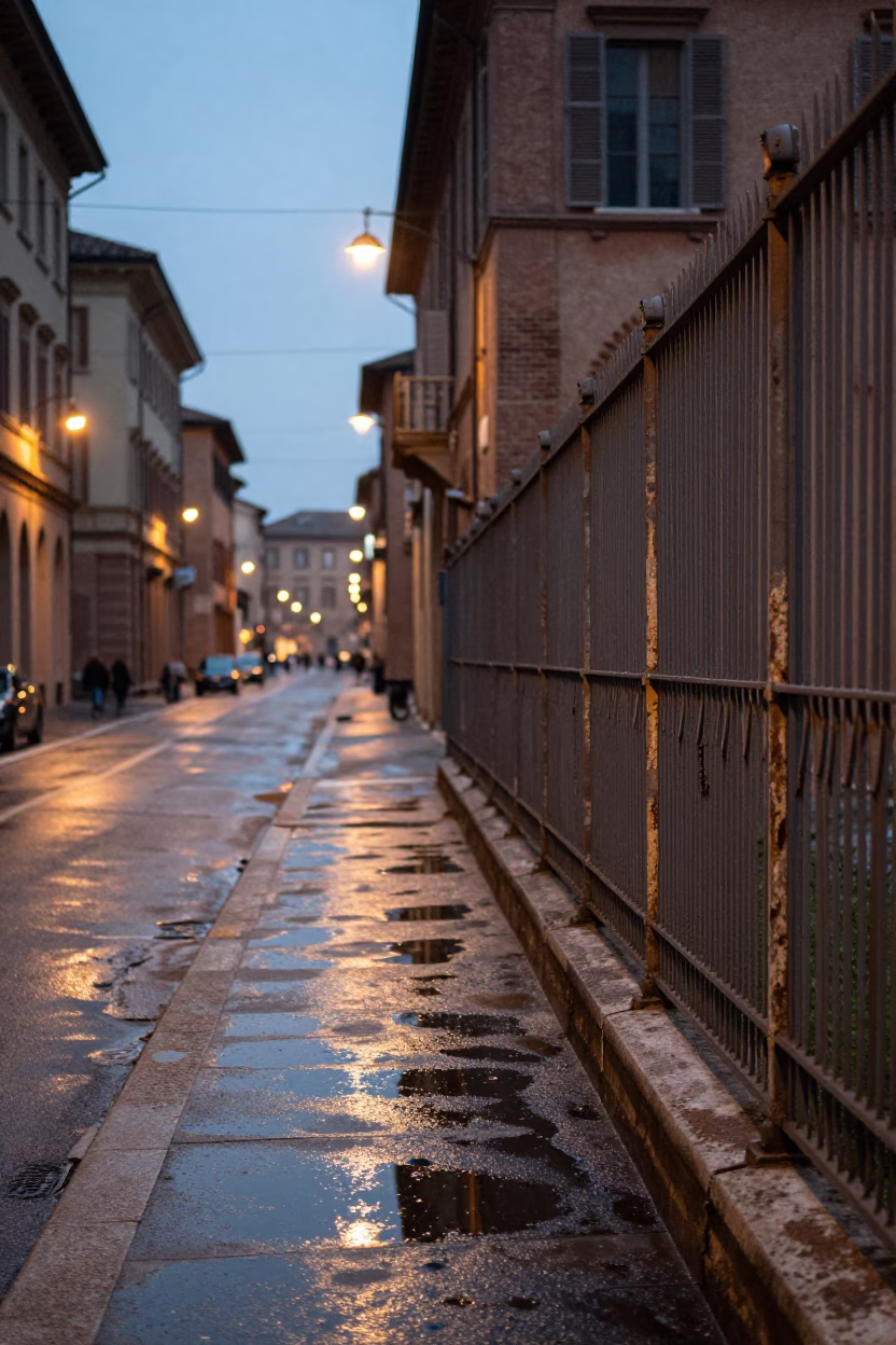 Evening Street Scene in Bologna Italy with Substation Fence and Puddle Reflections in in Bologna, Italy