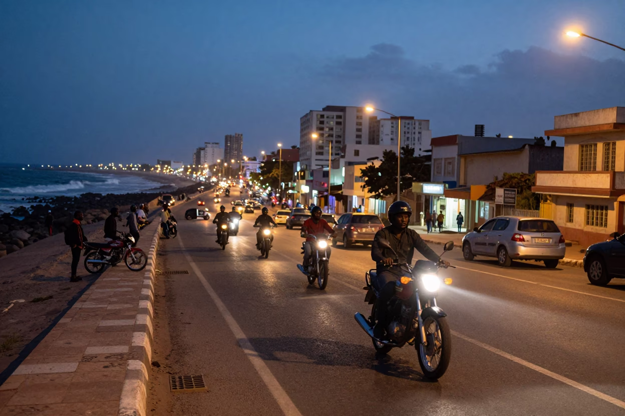 Evening street scene in Dakar Senegal with motorcycle and city lights glowing in in Dakar, Senegal