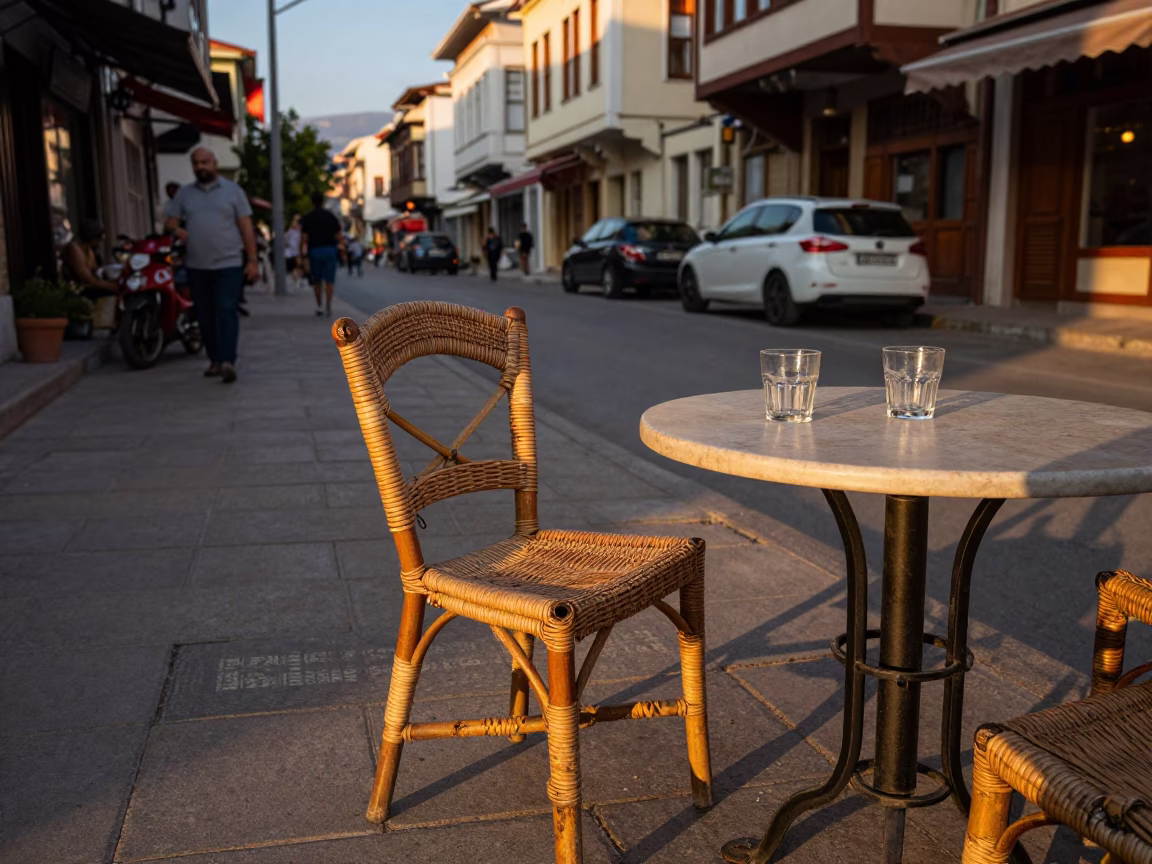 Evening Street Scene in Izmir Turkey with Rattan Chair and Glass Tumblers in in Izmir, Turkey