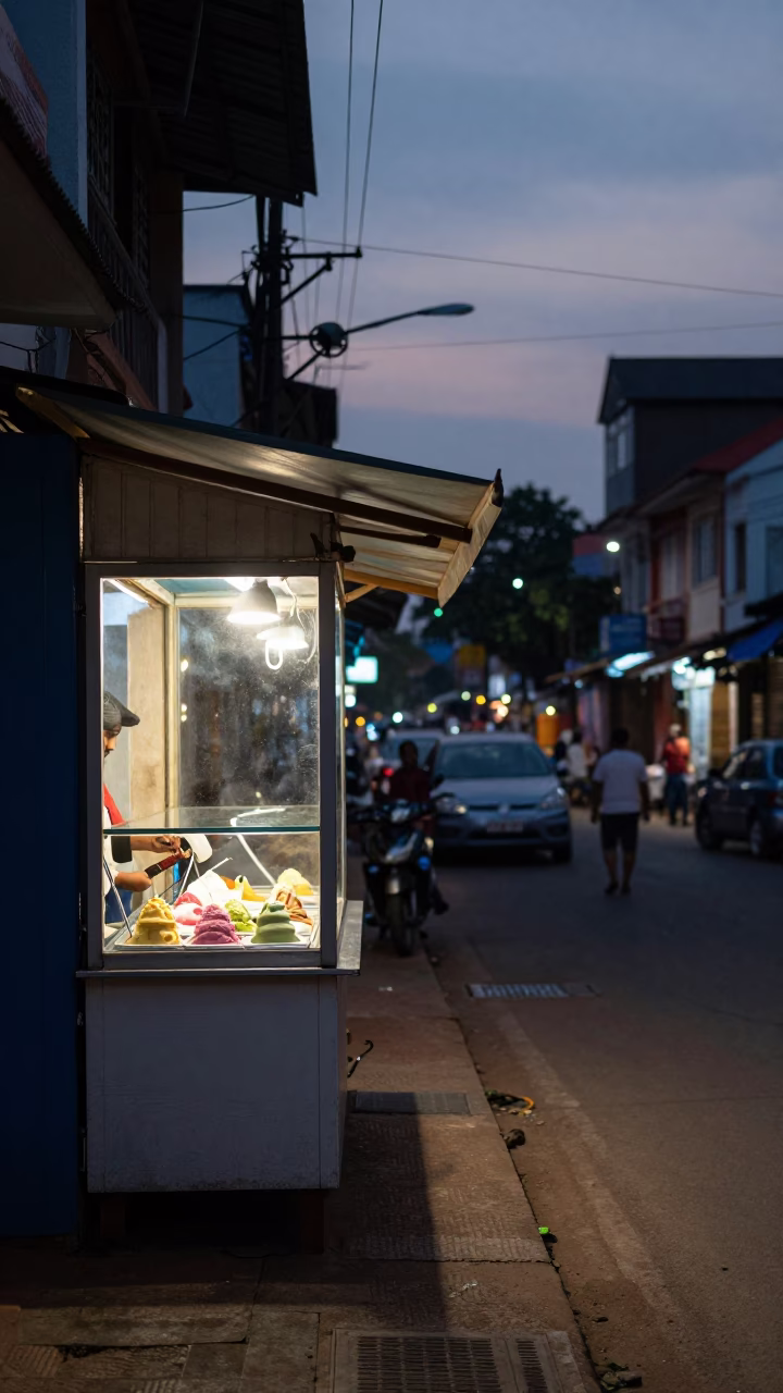 Evening Street Scene in Kochi India with Gelato Display and Local Shopfronts in in Kochi, India