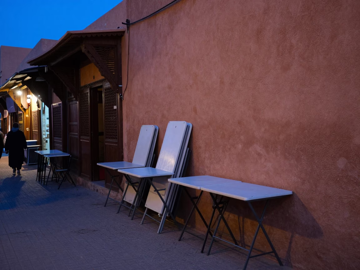 Evening street scene in Marrakech Morocco with folding tables and local activity in in Marrakech, Morocco