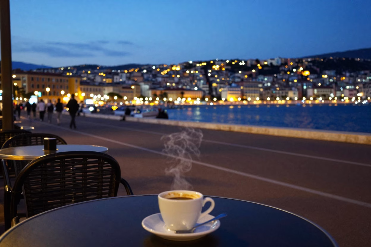 Evening street scene in Nice France with glowing city lights and local cafe table in in Nice, France