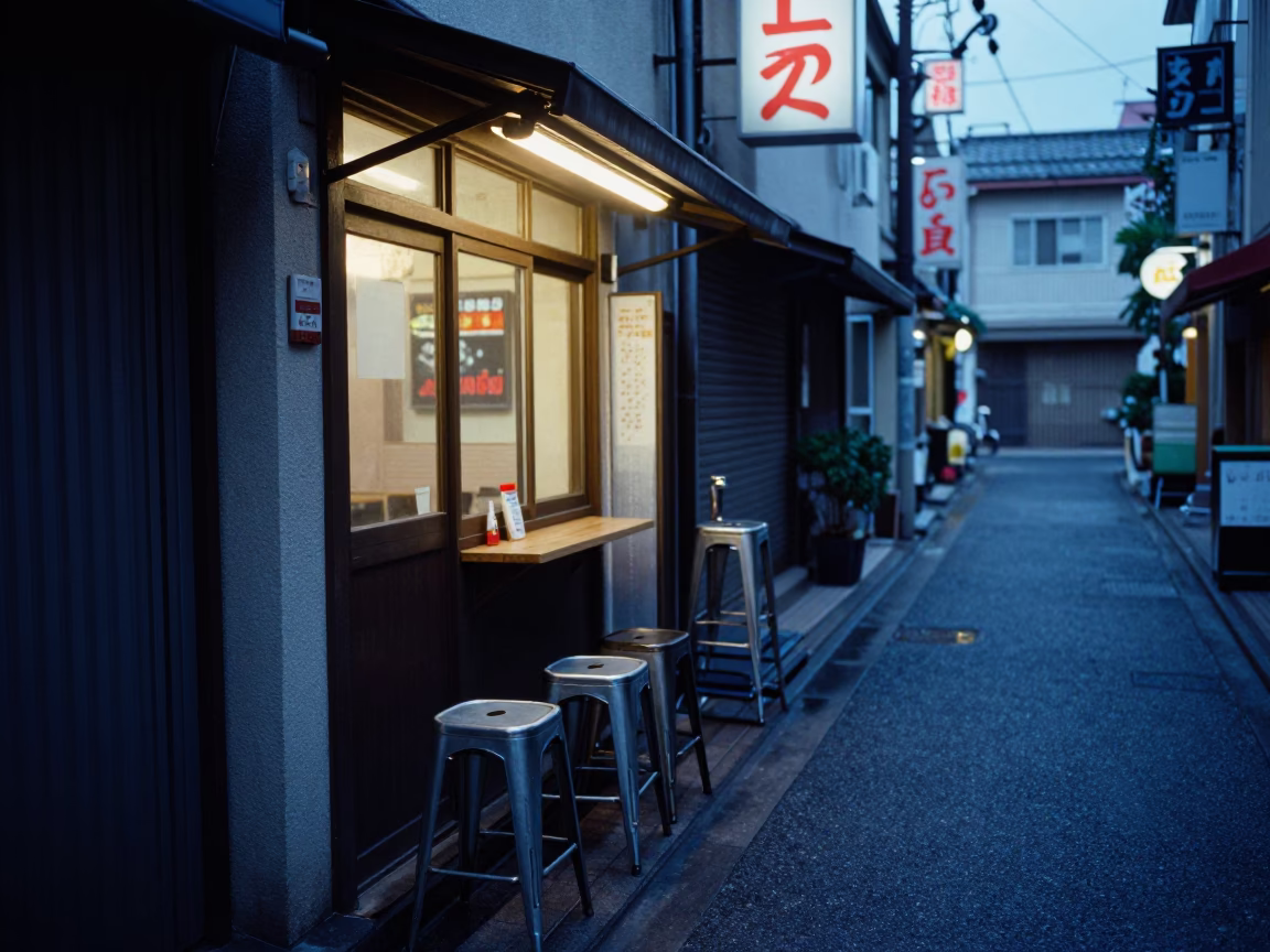 Evening Street Scene in Osaka Japan with Metal Stools and Neon Lights in in Osaka, Japan