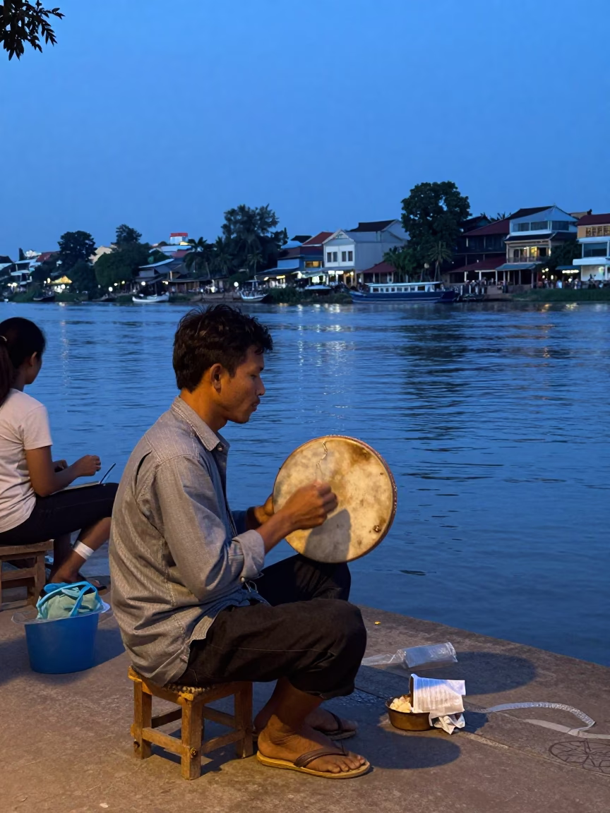 Evening Street Scene in Phnom Penh Cambodia with Traditional Tambourine Player in in Phnom Penh, Cambodia