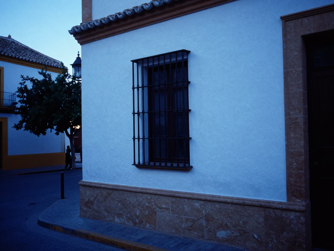 Evening Street Scene in Seville Spain with White Plaster Walls and Blue Twilight Light in in Seville, Spain