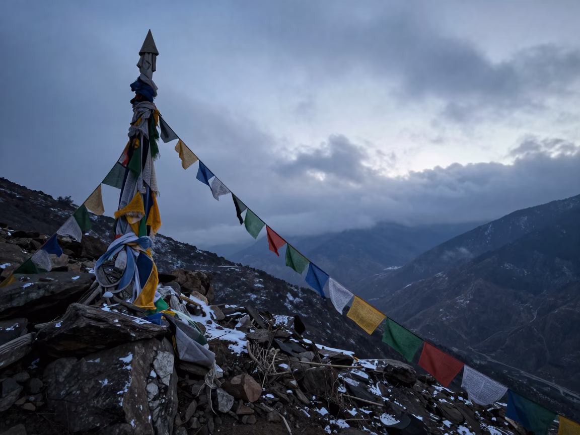 Faded Tibetan Prayer Flags at Predawn Mountain Saddle in at a rocky saddle overlooking a mountain valley near Shimla