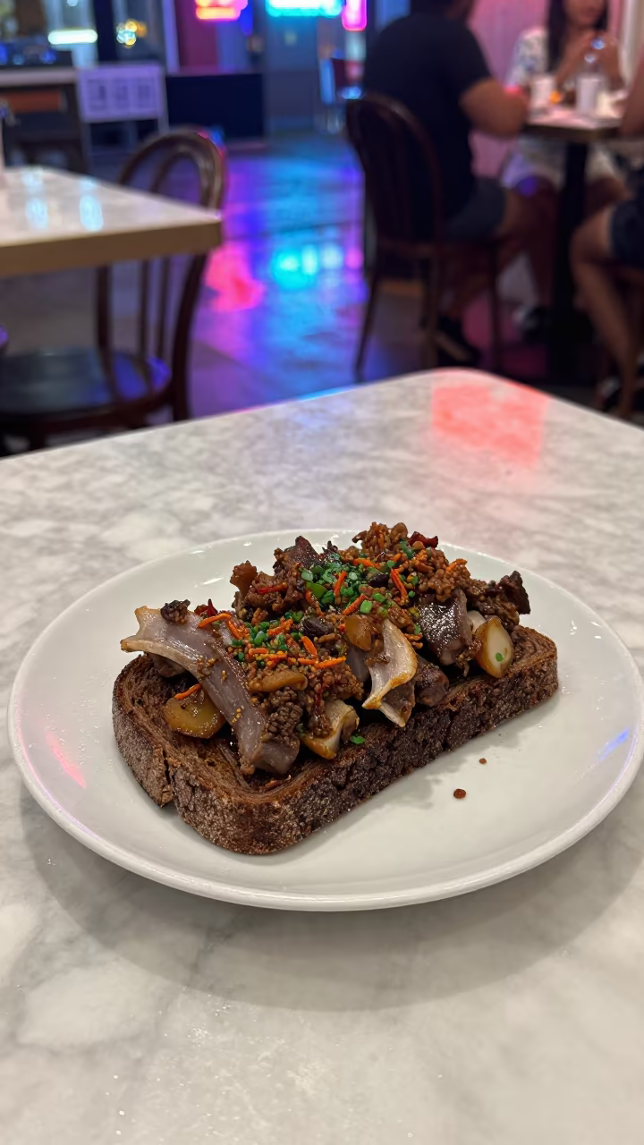 Faroese Rast Fermented Lamb on Rye Bread in on a marble cafe table in Lombok