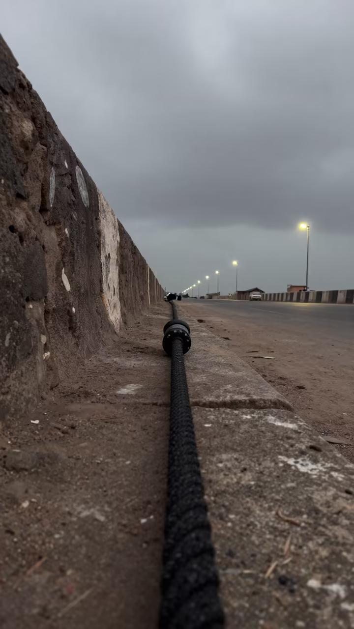 Fashion Security Rope Pressed Against Harbor Wall in against a wind-beaten harbor wall near Kano