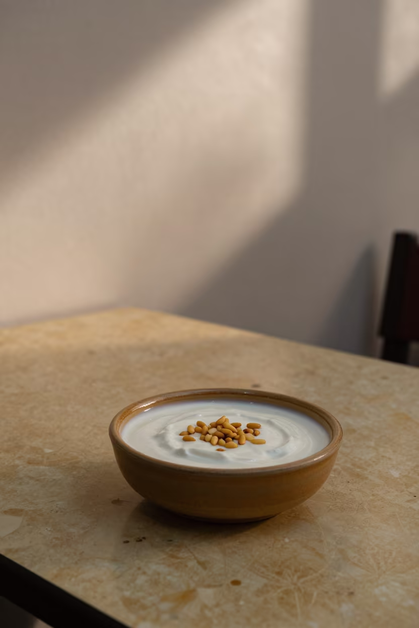 Fatteh Bowl with Yogurt and Pine Nuts in at a roadside diner table in Mohammedia