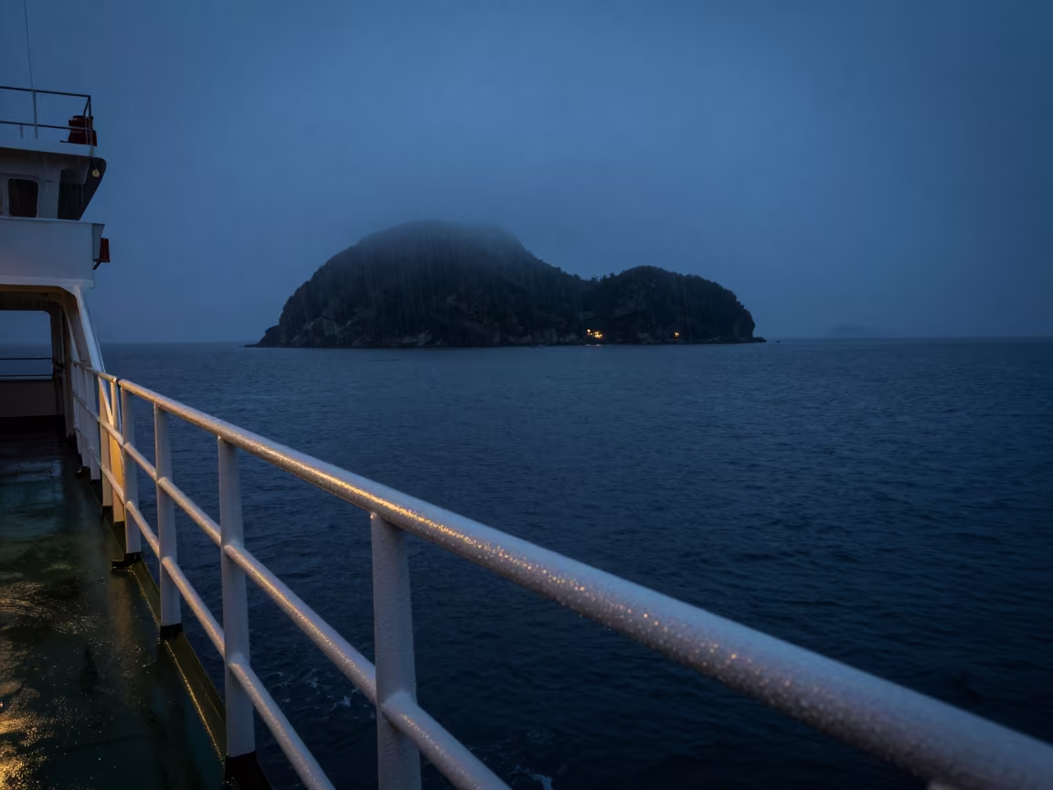 Ferry Approaching Misty Hebridean Island at Blue Hour in across a remote ferry crossing in Comoros