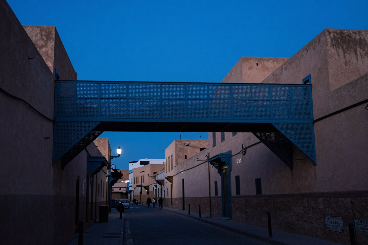 Fez Morocco indigo twilight street scene with perforated metal overpass and wet footsteps in in Fez, Morocco