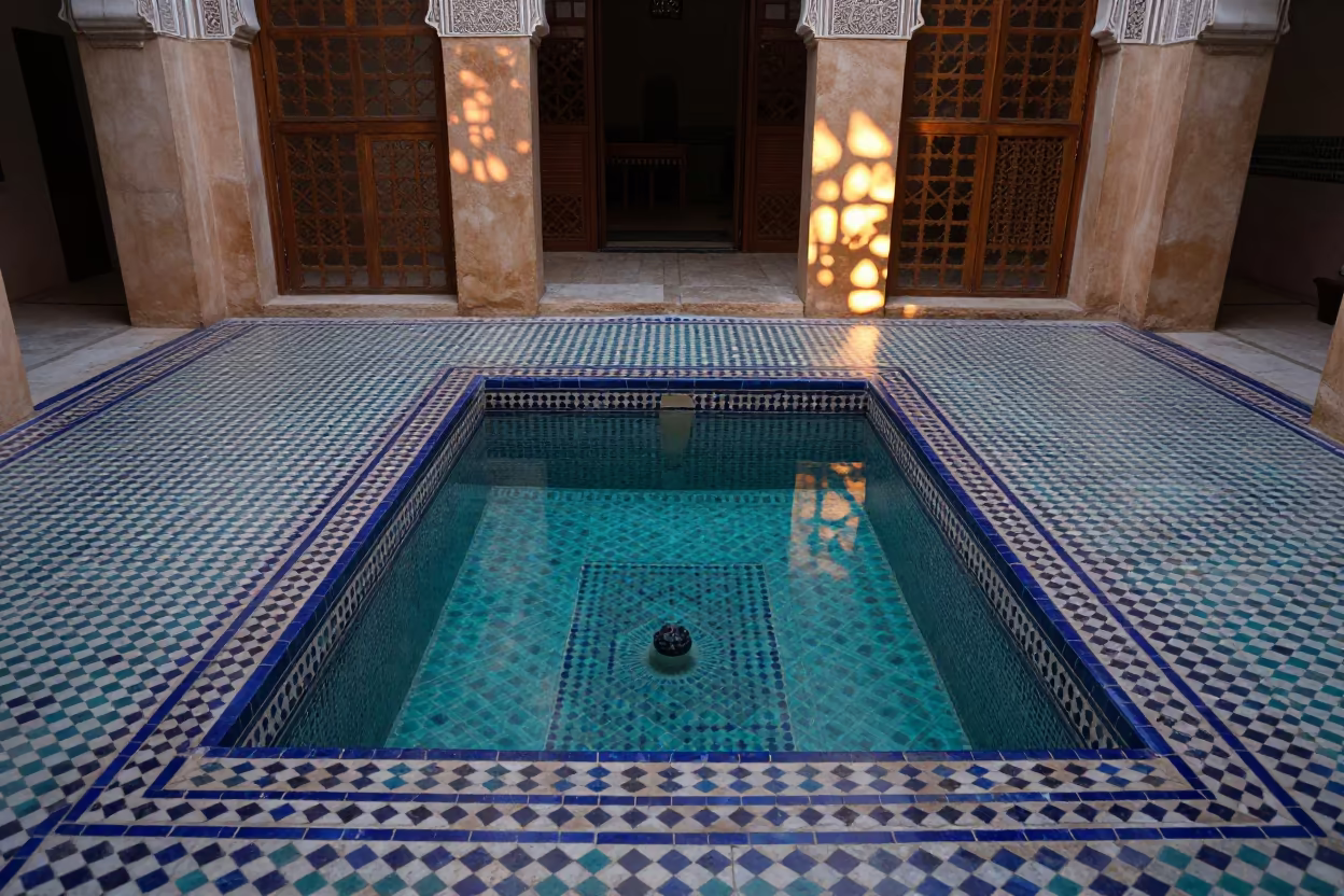 Fez Riad Pool Copper Light Cedar Shadows in inside a hotel lobby near Fez el-Bali, Fez