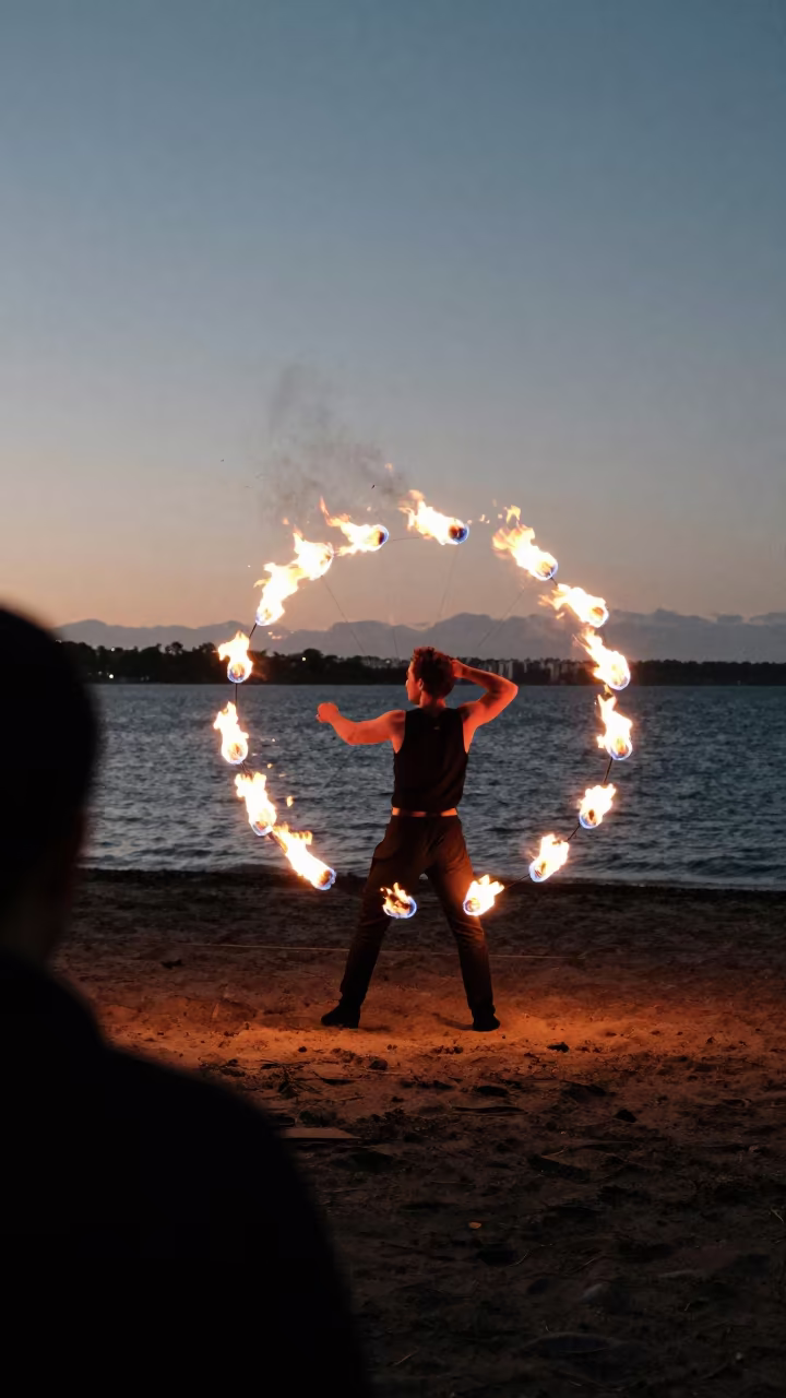 Fire Dancer Spins Poi Trails on Auckland Beach in at a harbor edge in Ponsonby, Auckland