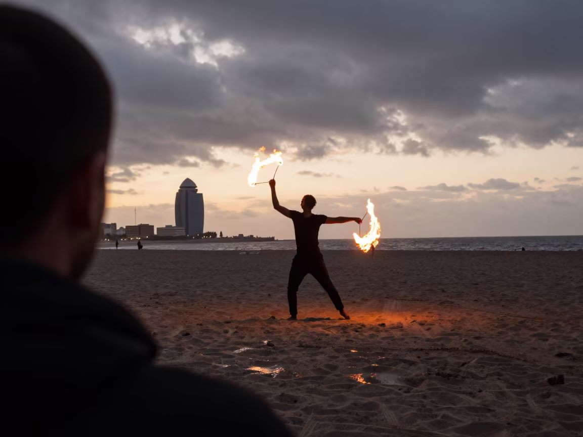 Fire Dancer Silhouette on Barcelona Beach at Sunset in near Gracia, Barcelona