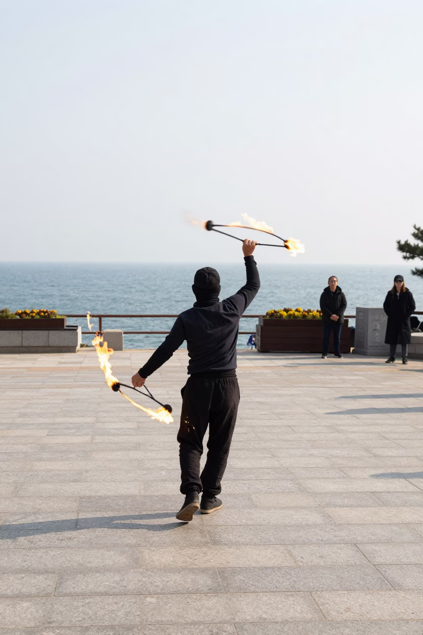 Fire Dancer Spinning Poi in Huinnyeoul Square in at a public square in Huinnyeoul, Busan