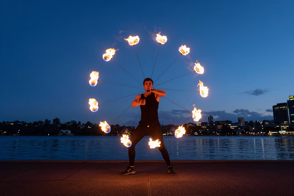 Fire Dancer Spinning Poi at Sydney Beach in near a riverside landing in Sydney