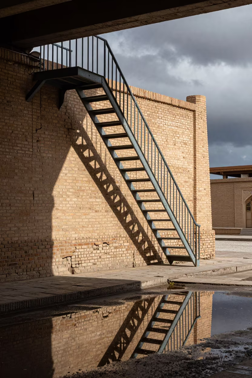 Fire Escape Reflection in Khiva Puddle in beneath a flickering underpass light in Khiva