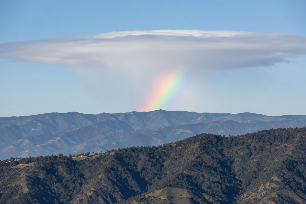 Fire Rainbow Arc Over Medellín Mountains in beneath fast-moving cloud bands near Medellín