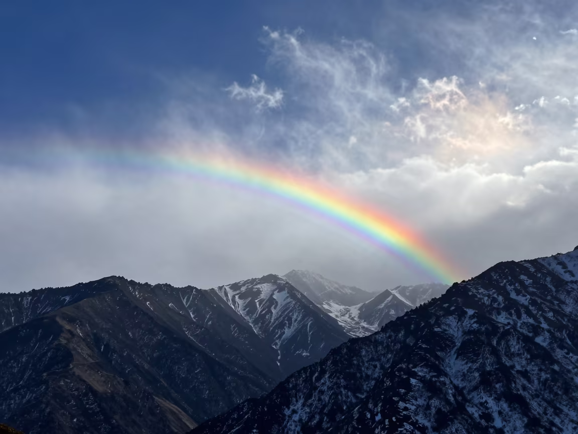 Fire Rainbow Over Uttarakhand Mountains in beneath fast-moving cloud bands in Uttarakhand