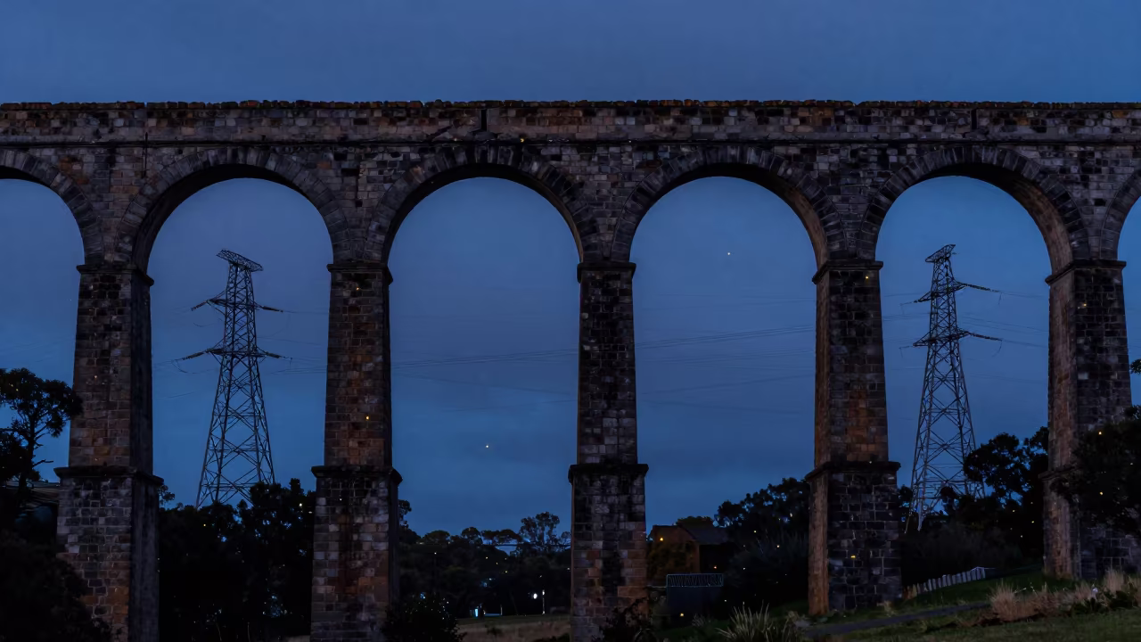 Fireflies Over Australian Aqueduct at Dusk in beneath transmission towers in Australia