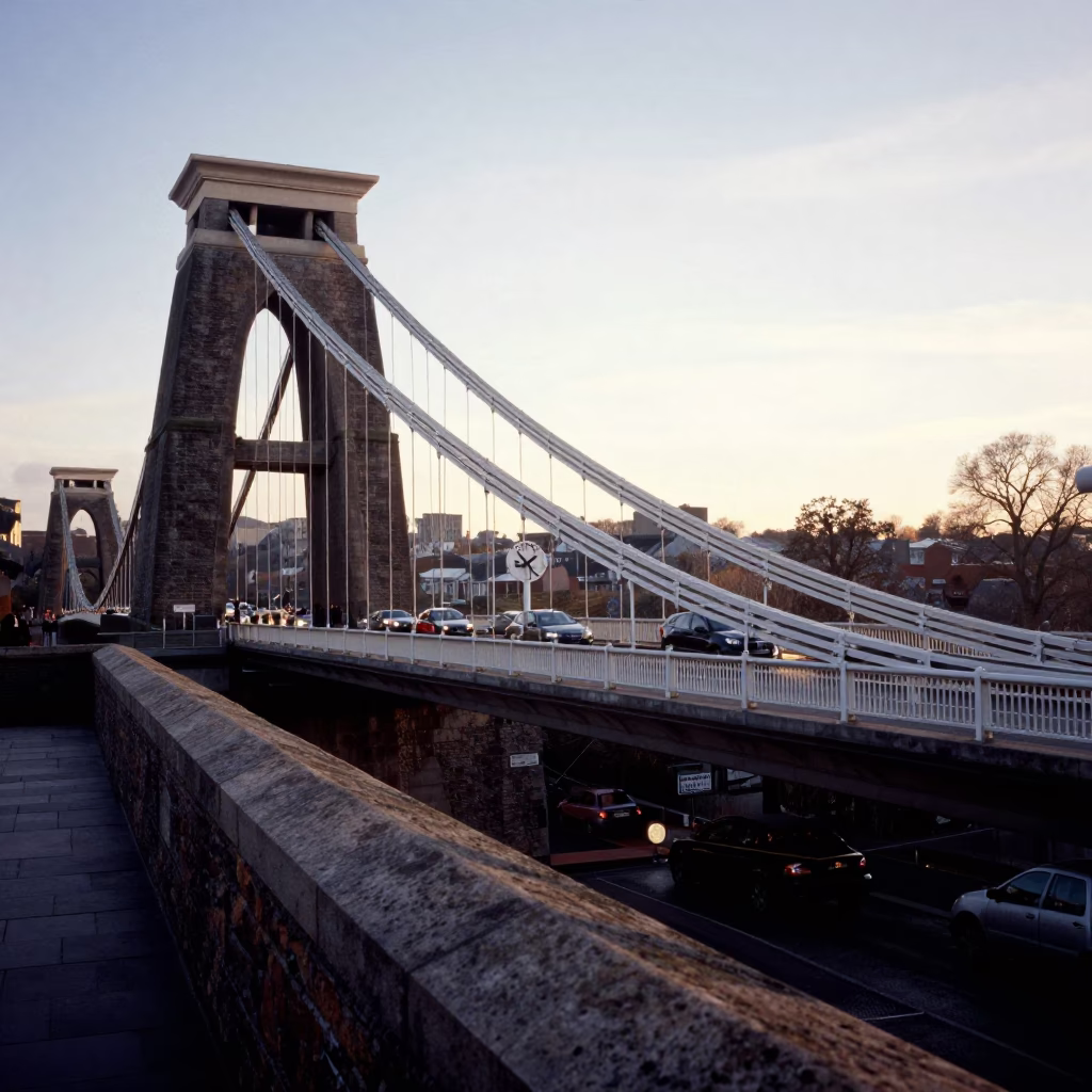 First Light Dawn on Bristol Suspension Bridge with Commuter Cyclist and City Skyline in in Bristol, United Kingdom