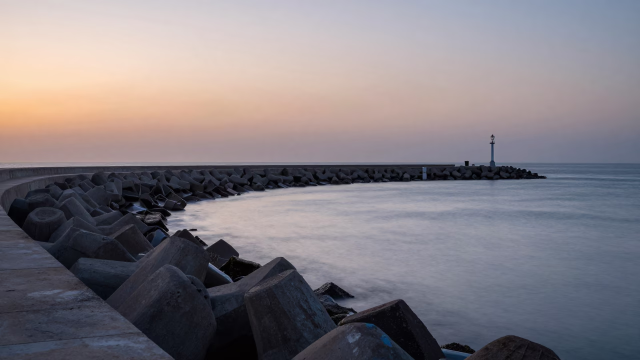 First Light Dawn Over Casablanca Harbor Breakwater Curve and Lonely Beacon in in Casablanca, Morocco