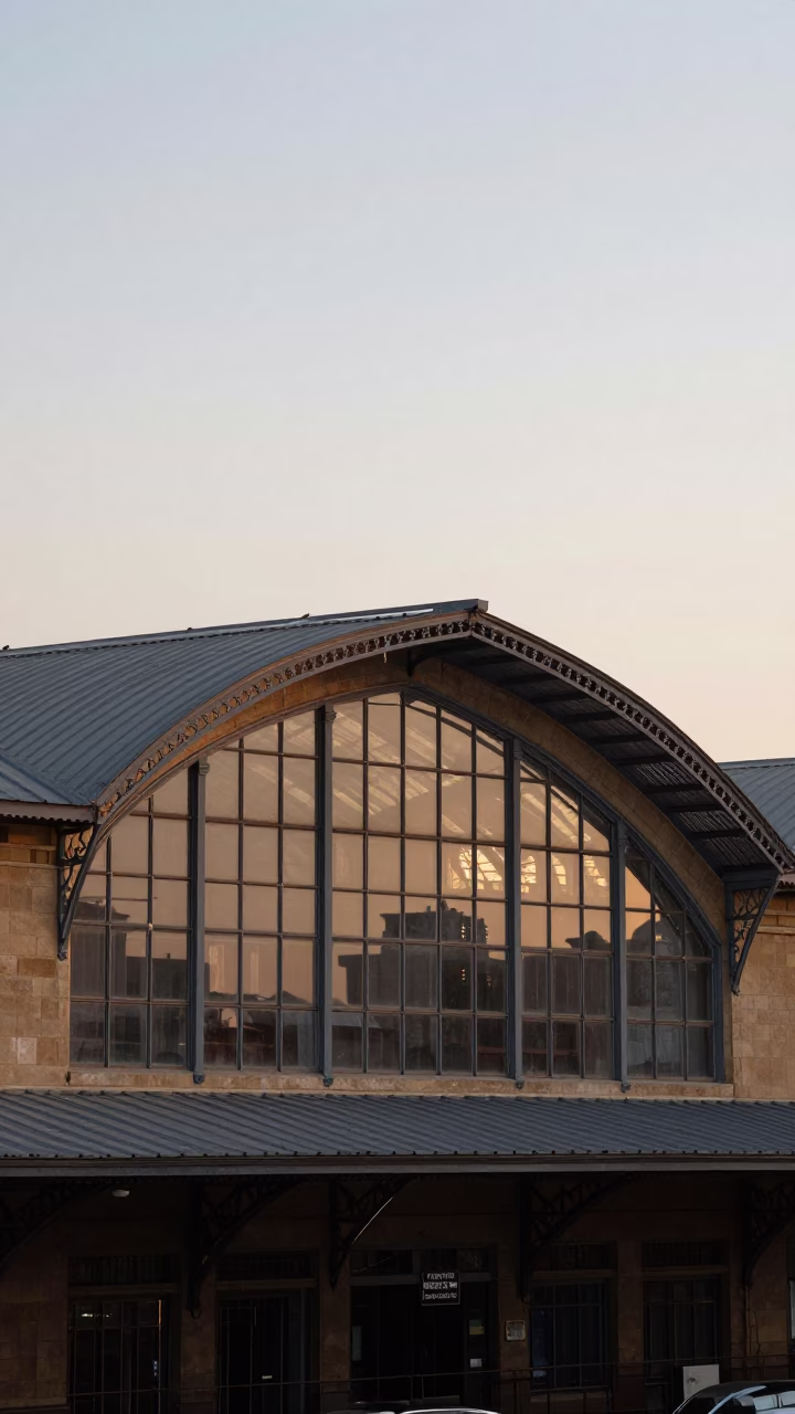 First Light Dawn Scene Outside Alexandria Train Station With Arched Roof And Passengers in in Alexandria, Egypt