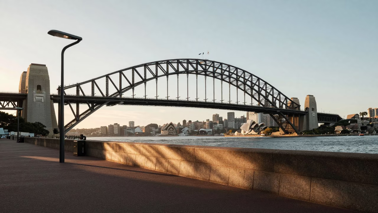 First Light Illuminates Sydney Harbour Bridge and Circular Quay Waterfront Promenade in in Sydney, New South Wales, Australia