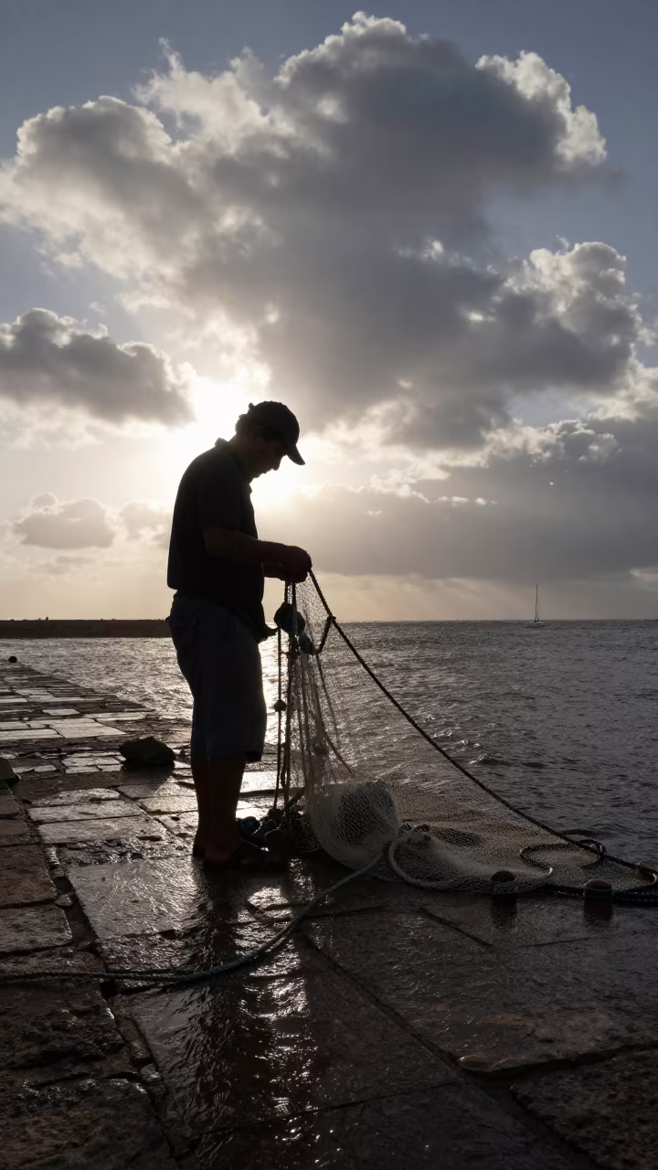 Fisherman Mending Nets on Harbor Wall at Dawn in at a roadside stop near Cartagena