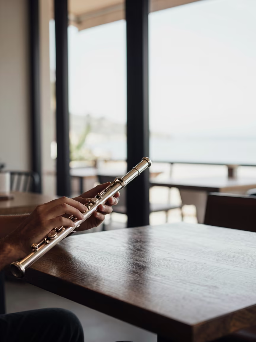 Flutist Playing Cadenza Noon Sunlight in on a cafe table by a window in Ar Ramtha