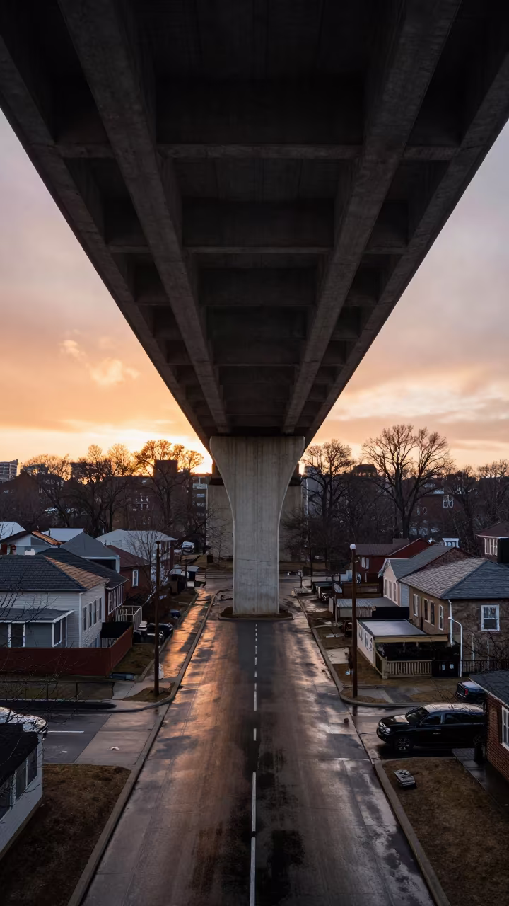 Flyover Shadow Slides Over Pittsburgh Rooftops in across a windy overpass interchange in Pittsburgh