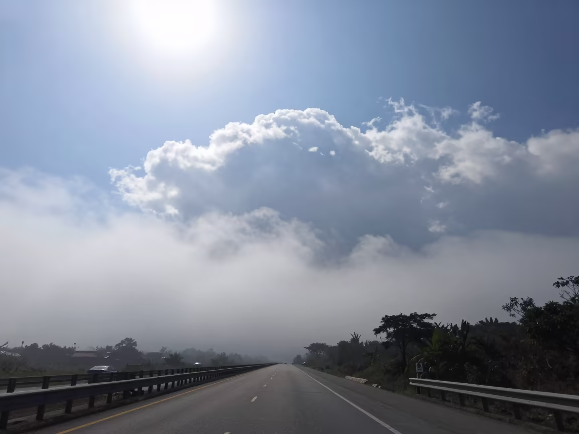 Fog Bank Swallows Coastal Highway Noon Zapopan in over a horizon of stacked thunderheads near Zapopan