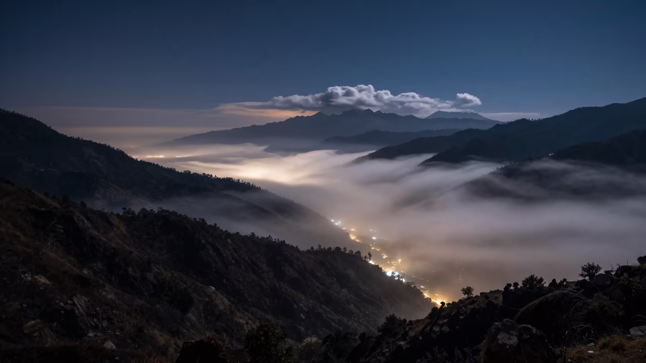 Fog Rolling Mountain Valley Under Starlight Near Pokhara in over a horizon of stacked thunderheads near Pokhara