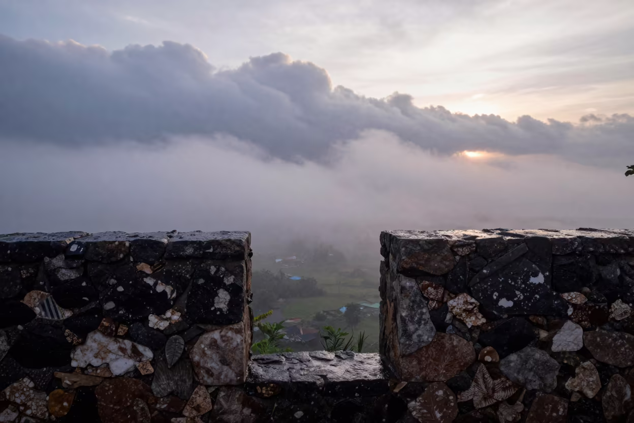 Fog Rolling Through Stone Wall Gap Over Thunderheads in over a horizon of stacked thunderheads in Togo