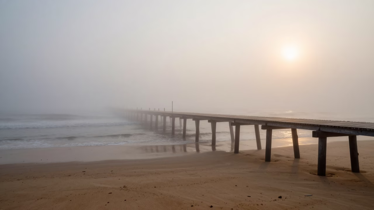 Fog Swallows Pier One Post at a Time in across a storm-bright plain near Thiruvananthapuram