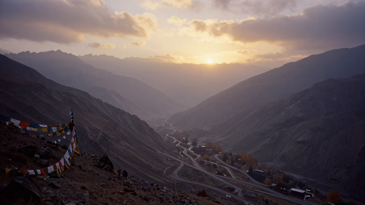 Foggy Mountain Pass Sunset Near Leh in on a wind-cut ridge below prayer flag lines near Leh