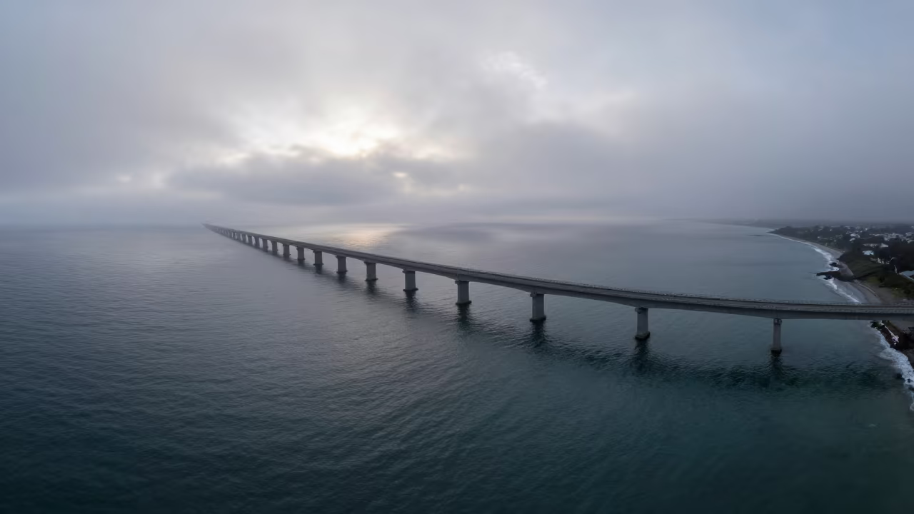 Foggy Viaduct Crossing Dawn Coastline Aerial View in far above surf-scalloped coastline near Castries